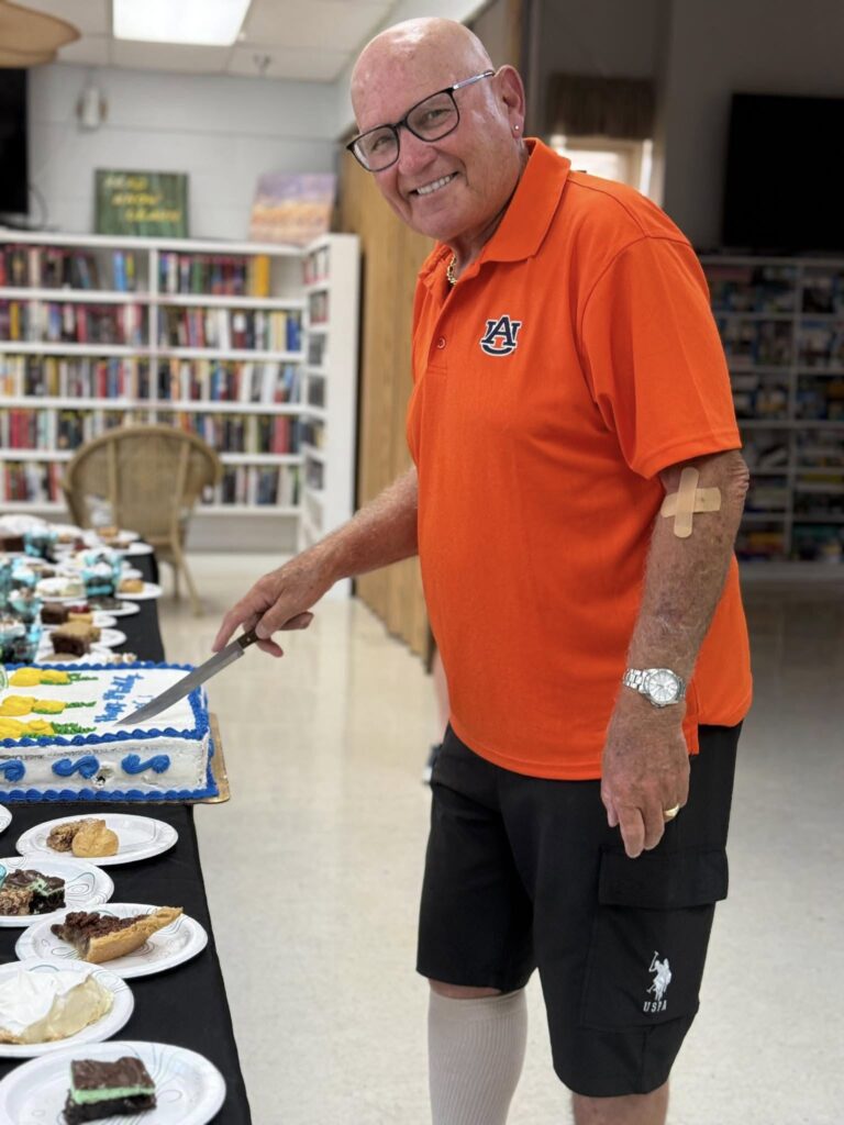 A resident slicing a cake at one of our many functions